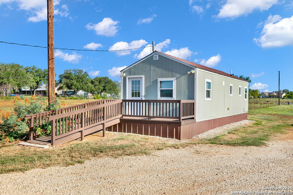 16020 Farm To Market Road 463 Lytle, TX 78052 - Photo 28 of 39 a view of a house with a yard and deck