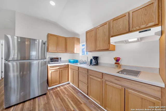 a view of a hallway with wooden floor and closet
