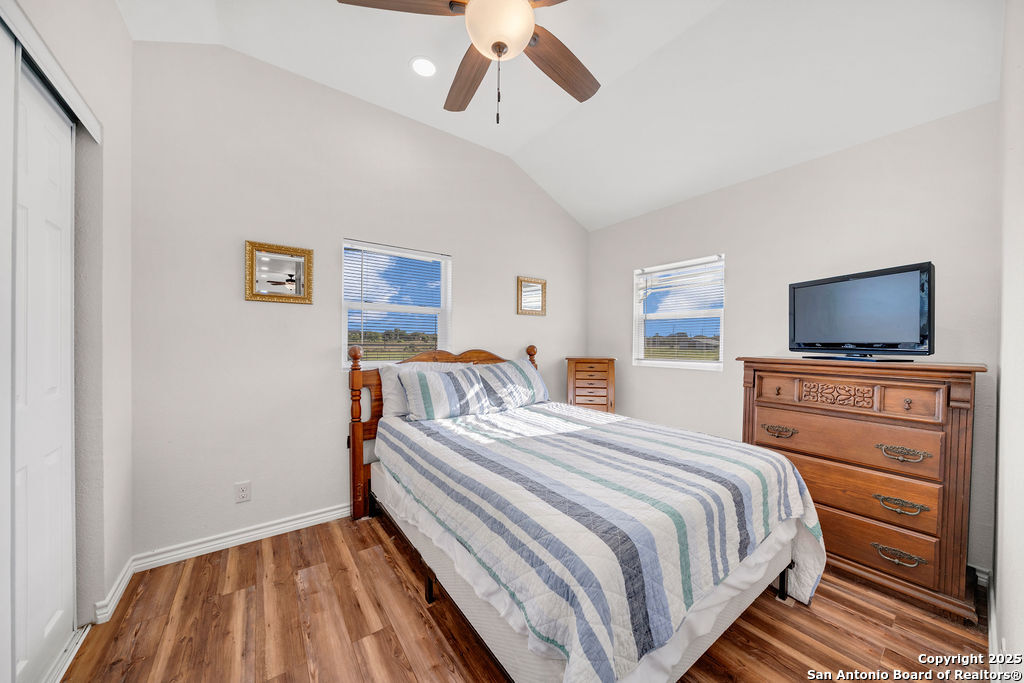 16020 Farm To Market Road 463 Lytle, TX 78052 - Photo 34 of 39 a bedroom with a bed and a flat screen tv