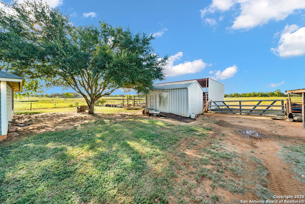 16020 Farm To Market Road 463 Lytle, TX 78052 - Photo 36 of 39 a view of a house with a yard and a garage