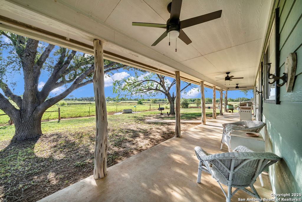 16020 Farm To Market Road 463 Lytle, TX 78052 - Photo 5 of 39 a view of a porch with furniture and a yard