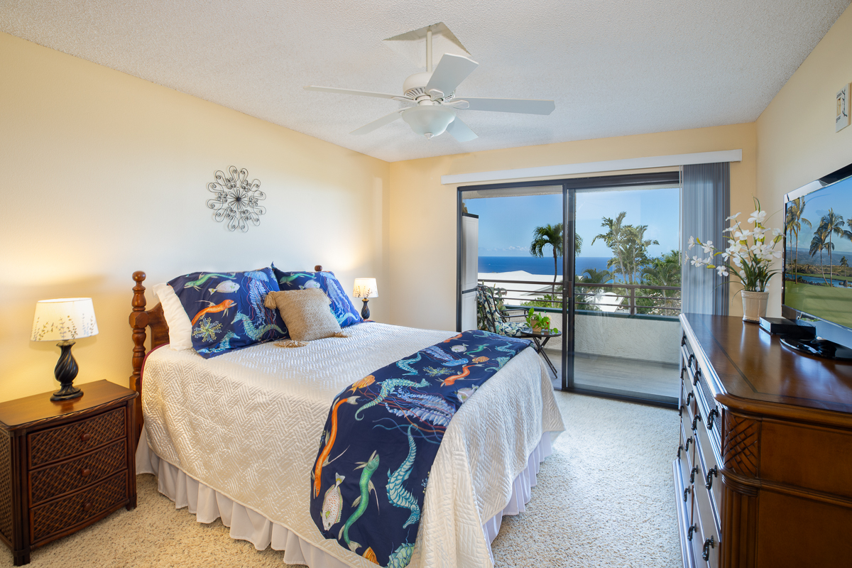 77-6585 Sea View Circle, Unit 104 Kailua-Kona, HI 96740 - Photo 11 of 23 a bedroom with a bed and a flat tv screen on dresser