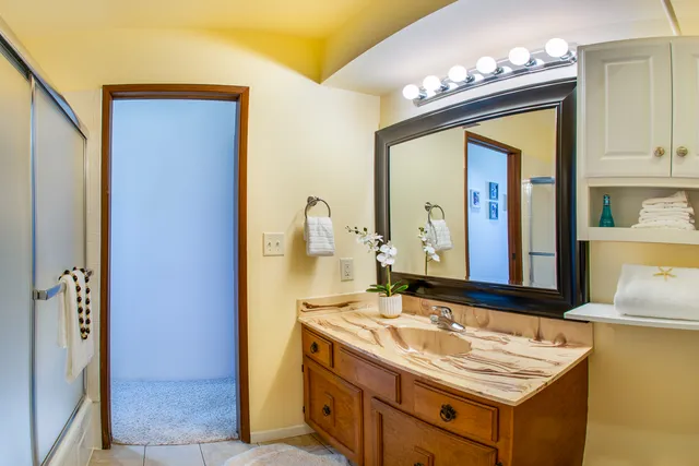 a bathroom with a sink vanity and a mirror