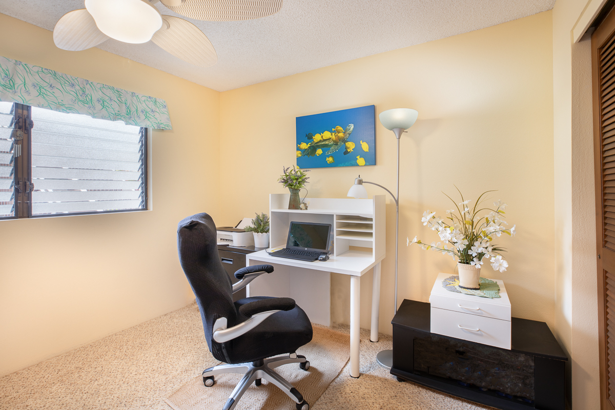 77-6585 Sea View Circle, Unit 104 Kailua-Kona, HI 96740 - Photo 19 of 23 a work room with furniture and wooden floor