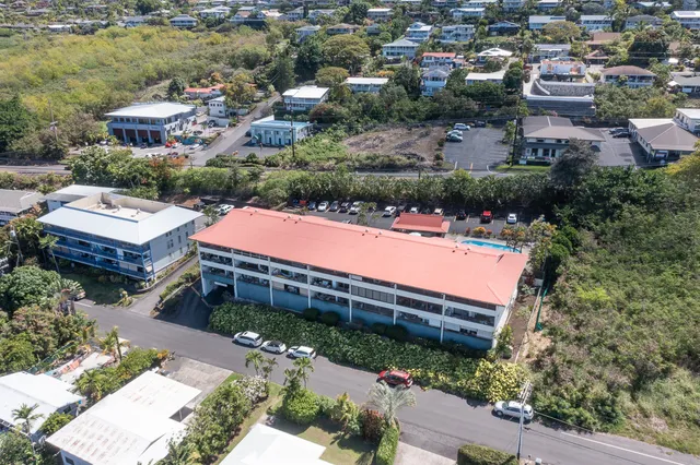 an aerial view of a house with yard swimming pool and outdoor seating