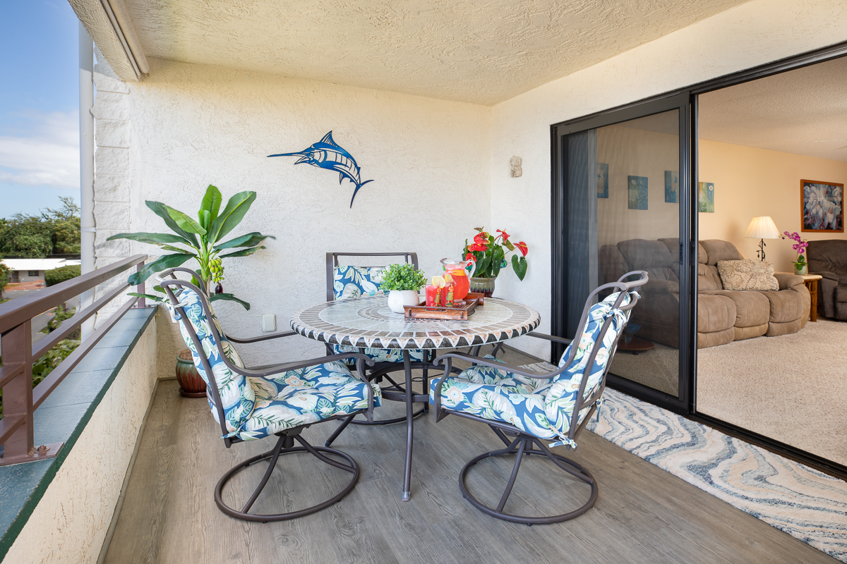 77-6585 Sea View Circle, Unit 104 Kailua-Kona, HI 96740 - Photo 5 of 23 a view of a dining room with furniture wooden floor and a chandelier