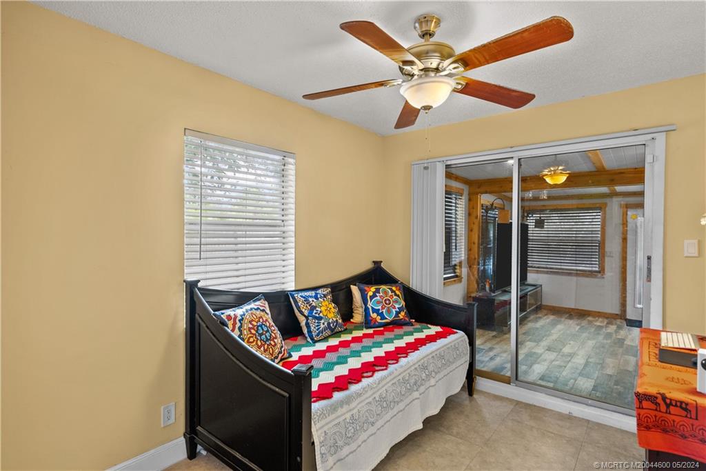 301 Lancaster Street Boca Raton, FL 33487 - Photo 13 of 20 a bedroom with a bed and a chandelier