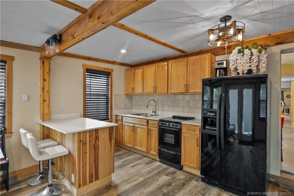 301 Lancaster Street Boca Raton, FL 33487 - Photo 14 of 20 a kitchen with stainless steel appliances granite countertop a stove a sink dishwasher and a refrigerator with wooden floor
