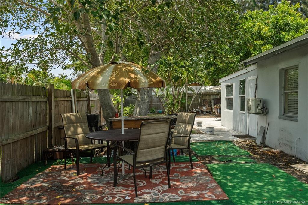 301 Lancaster Street Boca Raton, FL 33487 - Photo 19 of 20 a view of a chairs and table in backyard of the house