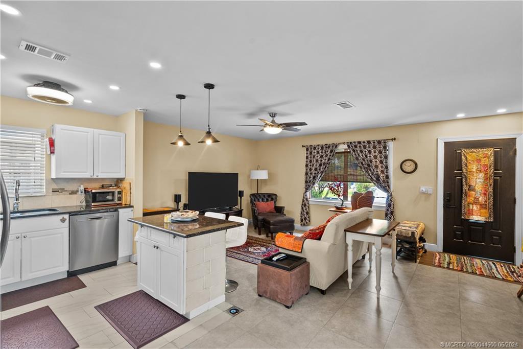 301 Lancaster Street Boca Raton, FL 33487 - Photo 4 of 20 a kitchen that has a lot of cabinets a sink and a stove in it