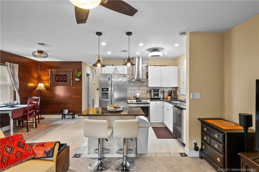 301 Lancaster Street Boca Raton, FL 33487 - Photo 6 of 20 a kitchen with cabinets and chairs