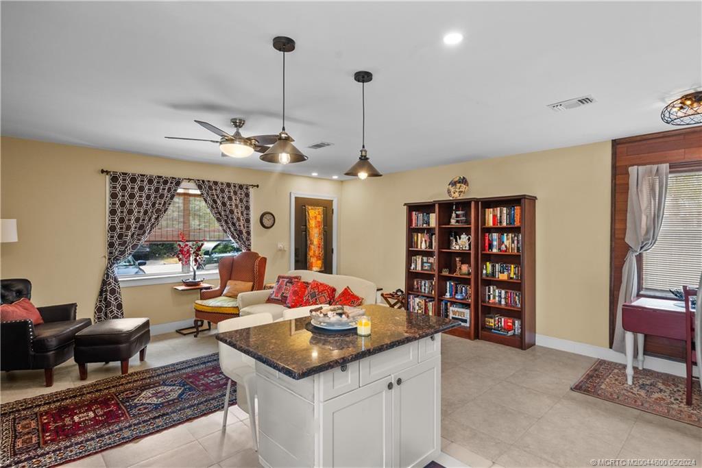 301 Lancaster Street Boca Raton, FL 33487 - Photo 7 of 20 a living room with furniture a rug and a chandelier