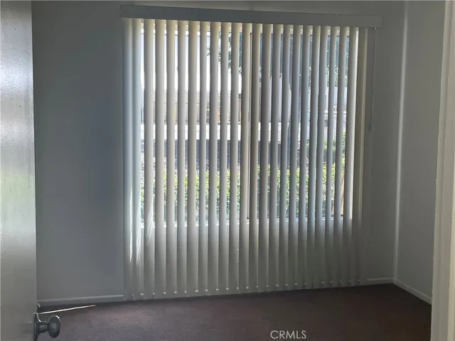a bathroom with a granite countertop toilet and a sink
