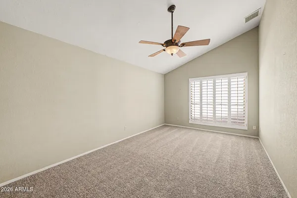 a view of room with a ceiling fan and window