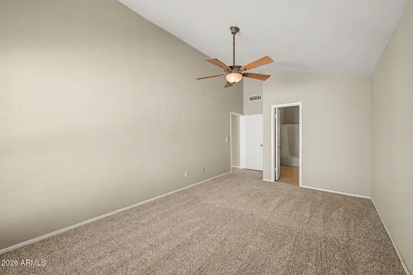 a view of an empty room and a ceiling fan