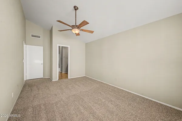 a view of a room with a ceiling fan and a window