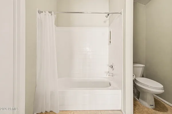 a bathroom with a shower and a toilet