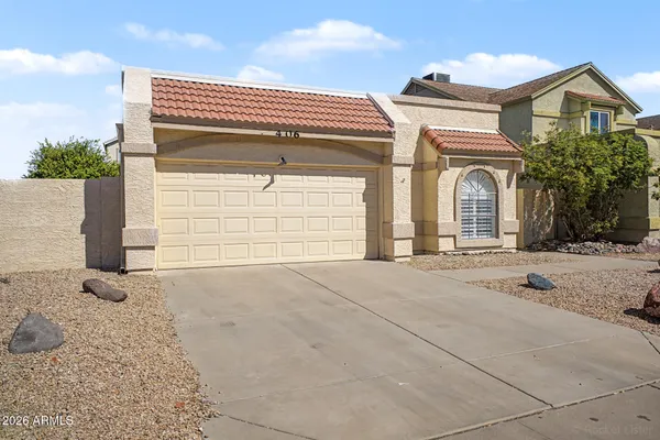 a view of a house with a yard and garage