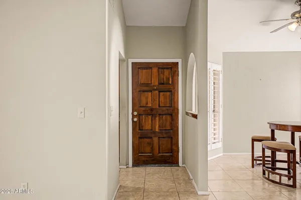 a view of a hallway with wooden floor and a bathroom