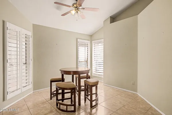 a dining room with furniture and window