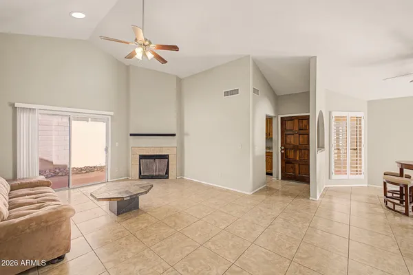 a living room with furniture a fireplace and a chandelier