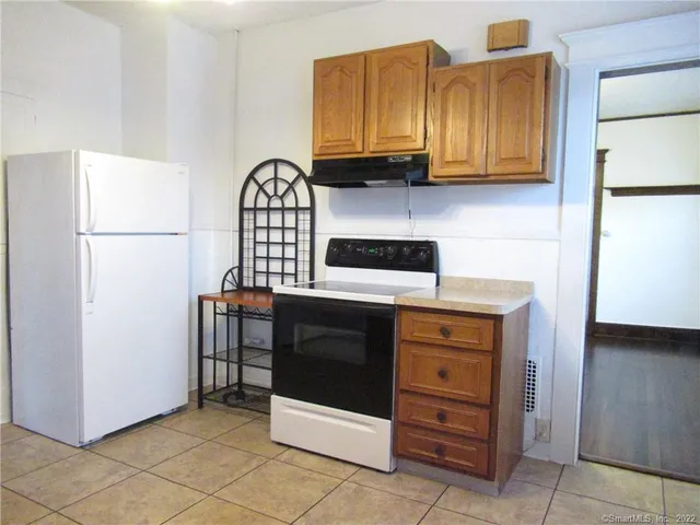 a kitchen with stainless steel appliances granite countertop a refrigerator and a stove