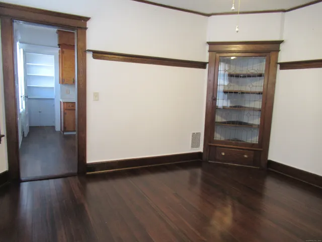 a view of a room with wooden floor