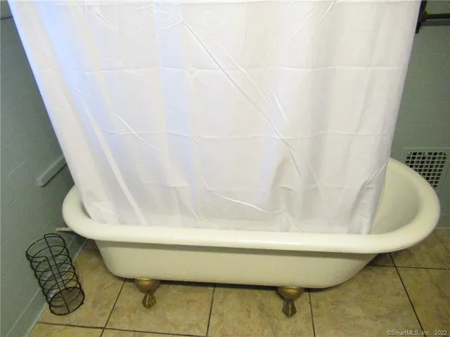 a bathroom with a bathtub and shower