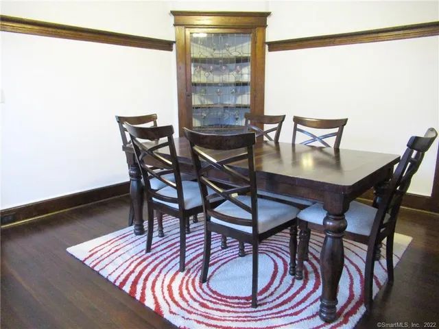 a view of a dining room with furniture wooden floor and a window