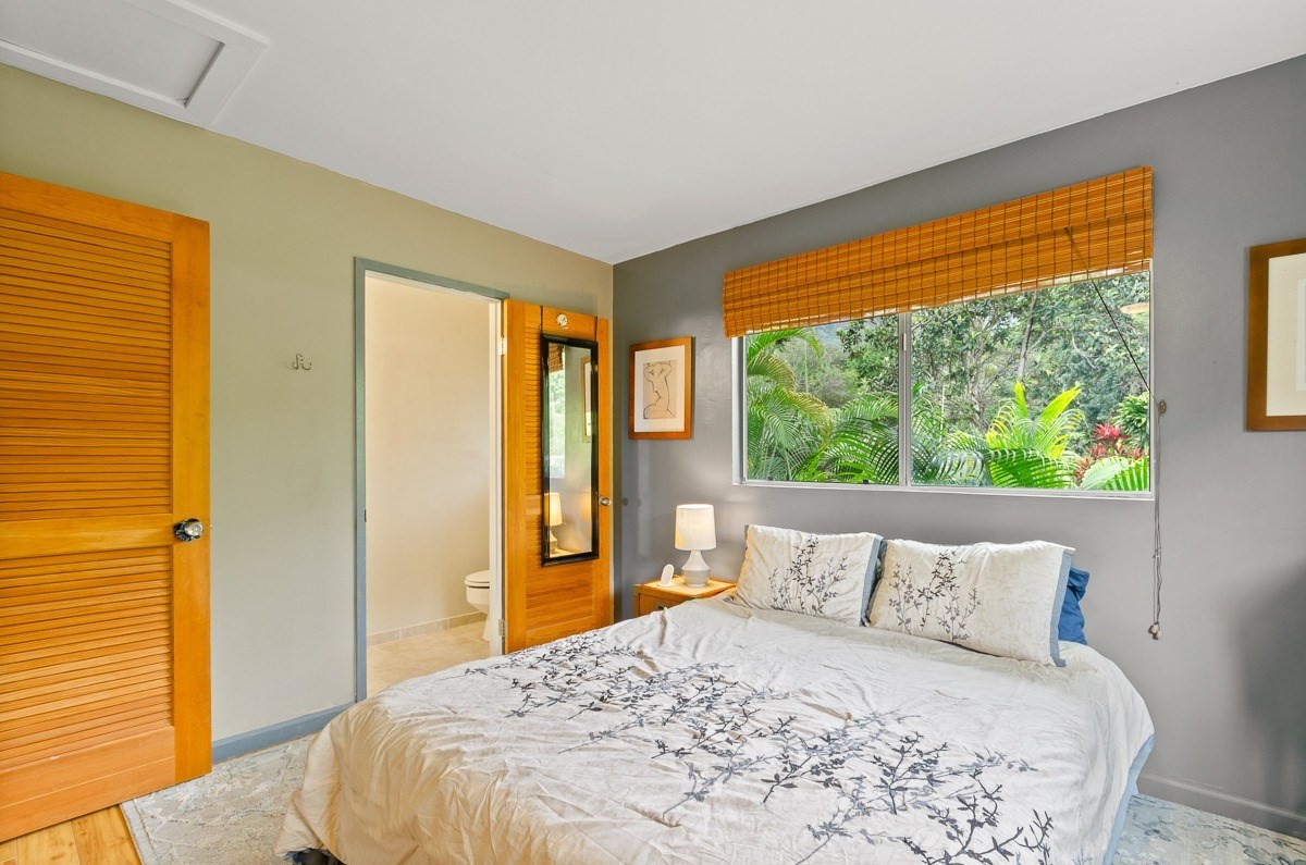 83-5434-C Middle Keei Road Captain Cook, HI 96704 - Photo 11 of 30 a bedroom with a bed and glass window