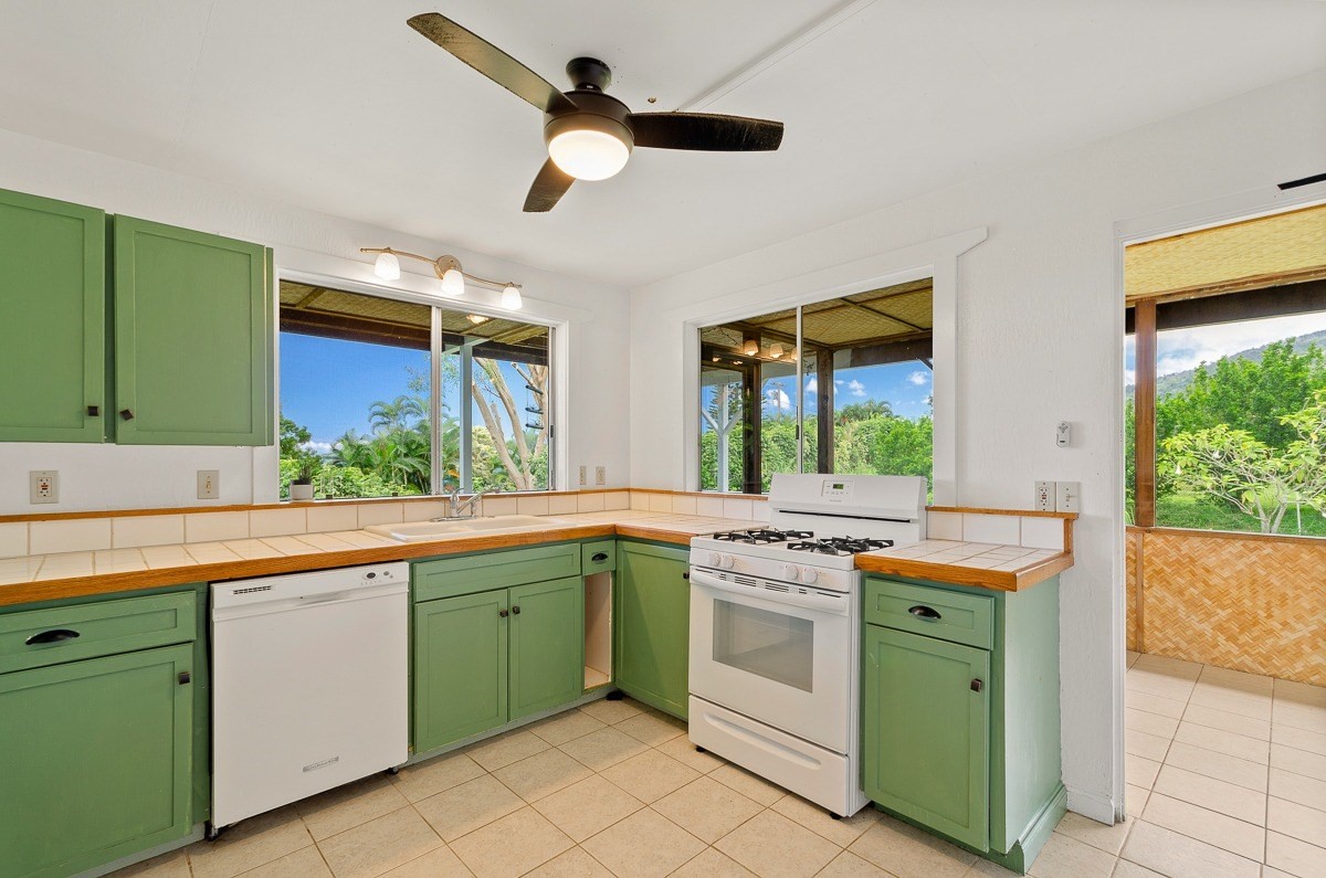 83-5434-C Middle Keei Road Captain Cook, HI 96704 - Photo 19 of 30 a kitchen with a stove sink and dishwasher with wooden floor