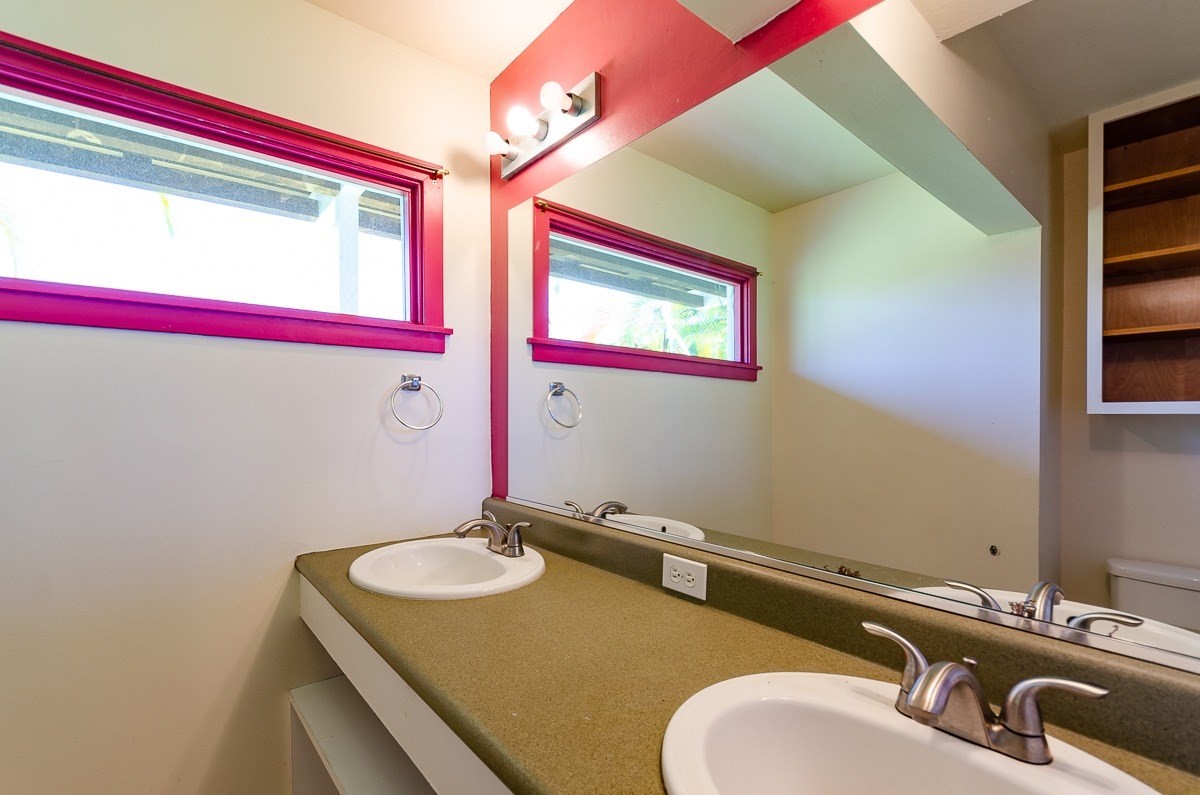 83-5434-C Middle Keei Road Captain Cook, HI 96704 - Photo 22 of 30 a bathroom with a granite countertop sink and a mirror