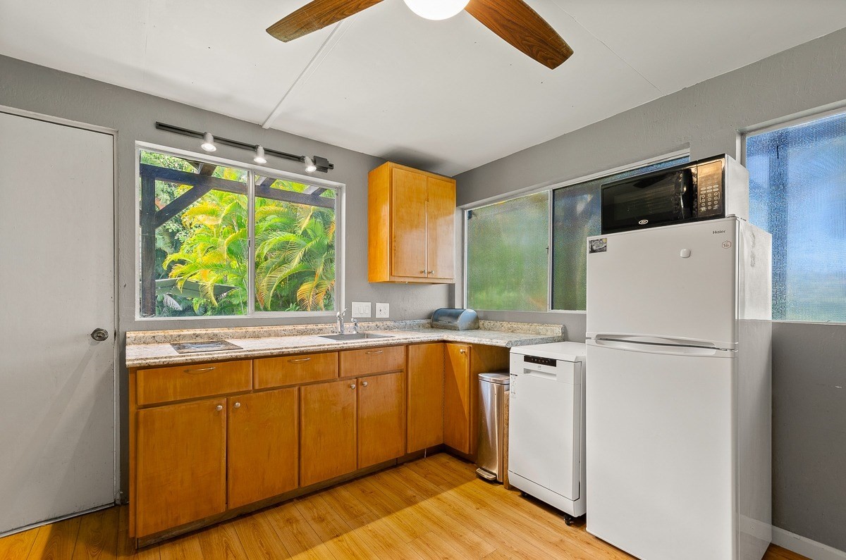 83-5434-C Middle Keei Road Captain Cook, HI 96704 - Photo 24 of 30 a white refrigerator freezer sitting inside of a kitchen