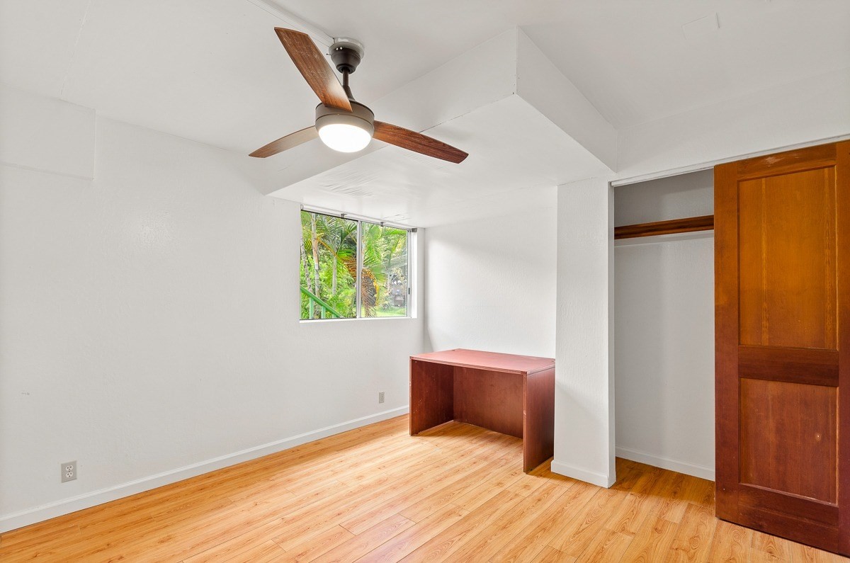 83-5434-C Middle Keei Road Captain Cook, HI 96704 - Photo 26 of 30 an empty room with wooden floor closet and windows