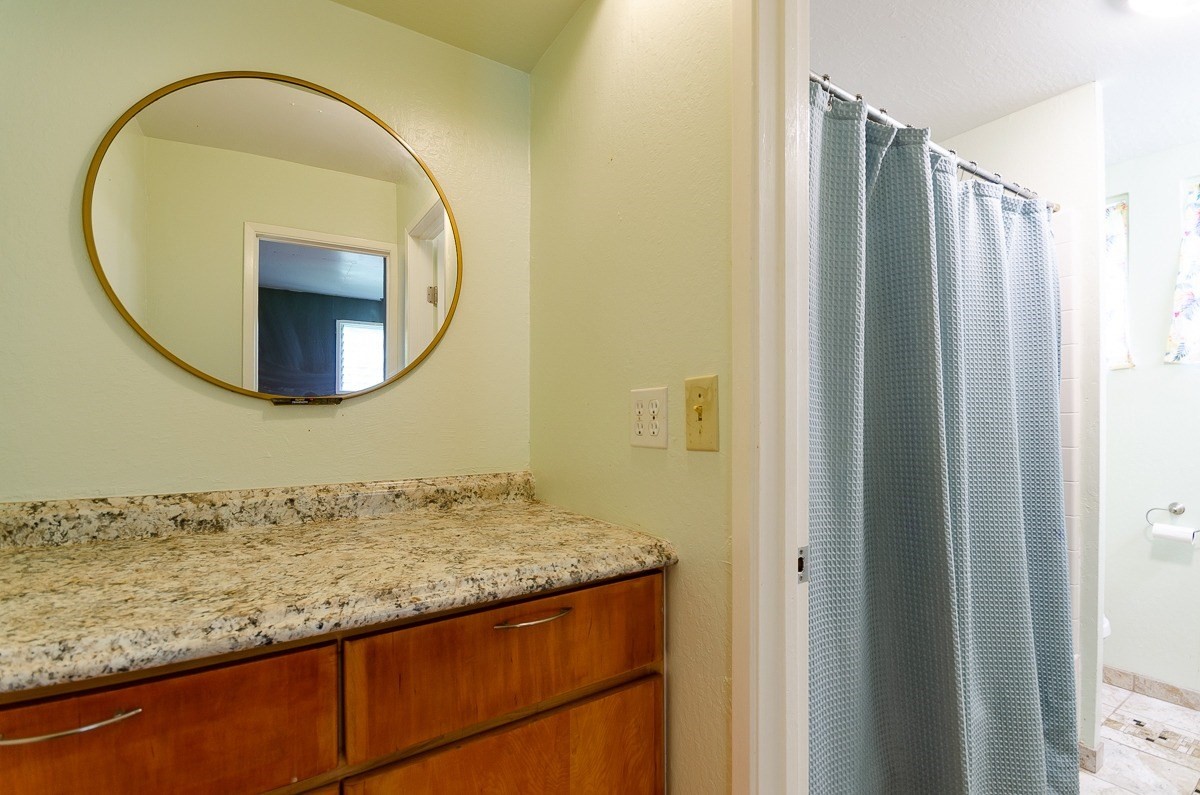 83-5434-C Middle Keei Road Captain Cook, HI 96704 - Photo 27 of 30 a bathroom with a granite countertop sink and a mirror