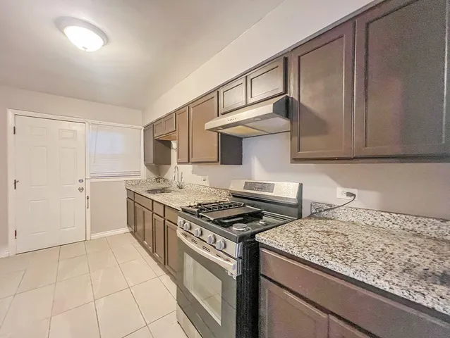 a kitchen with stainless steel appliances granite countertop a stove and a sink