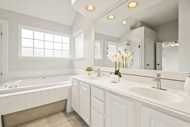 a bathroom with a sink double vanity next to a window