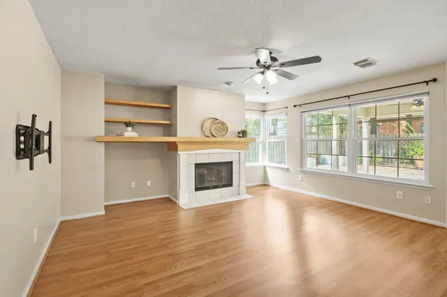 a view of a livingroom with a fireplace and window