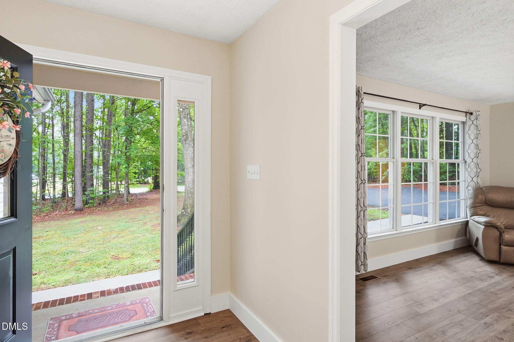 1925 Old Allensville Road Roxboro, NC 27574 - Photo 26 of 58 a view of an empty room with wooden floor and a window