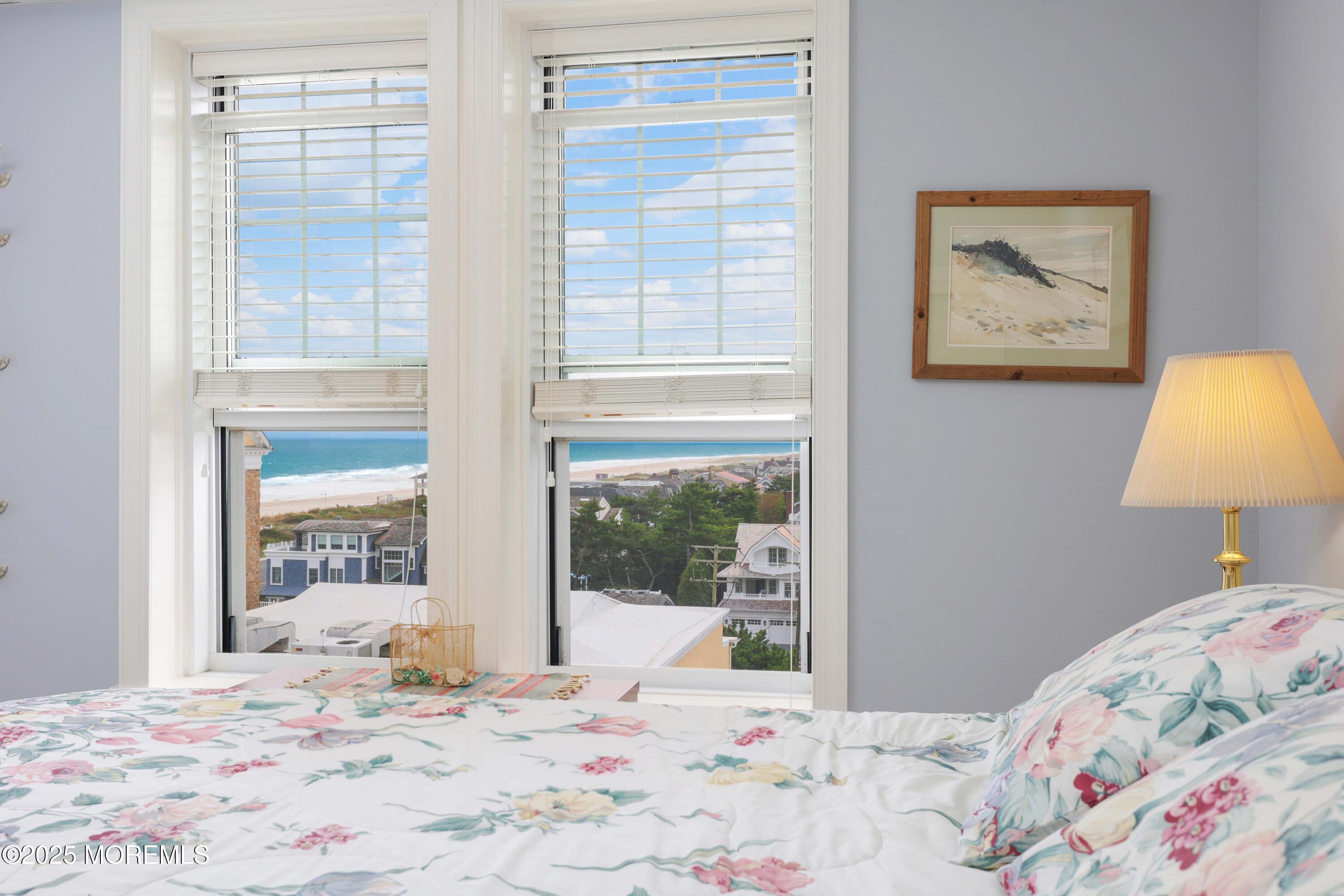 700 Ocean Avenue, Unit 531 Spring Lake, NJ 07762 - Photo 14 of 42 a bedroom with a bed and a painting on the wall