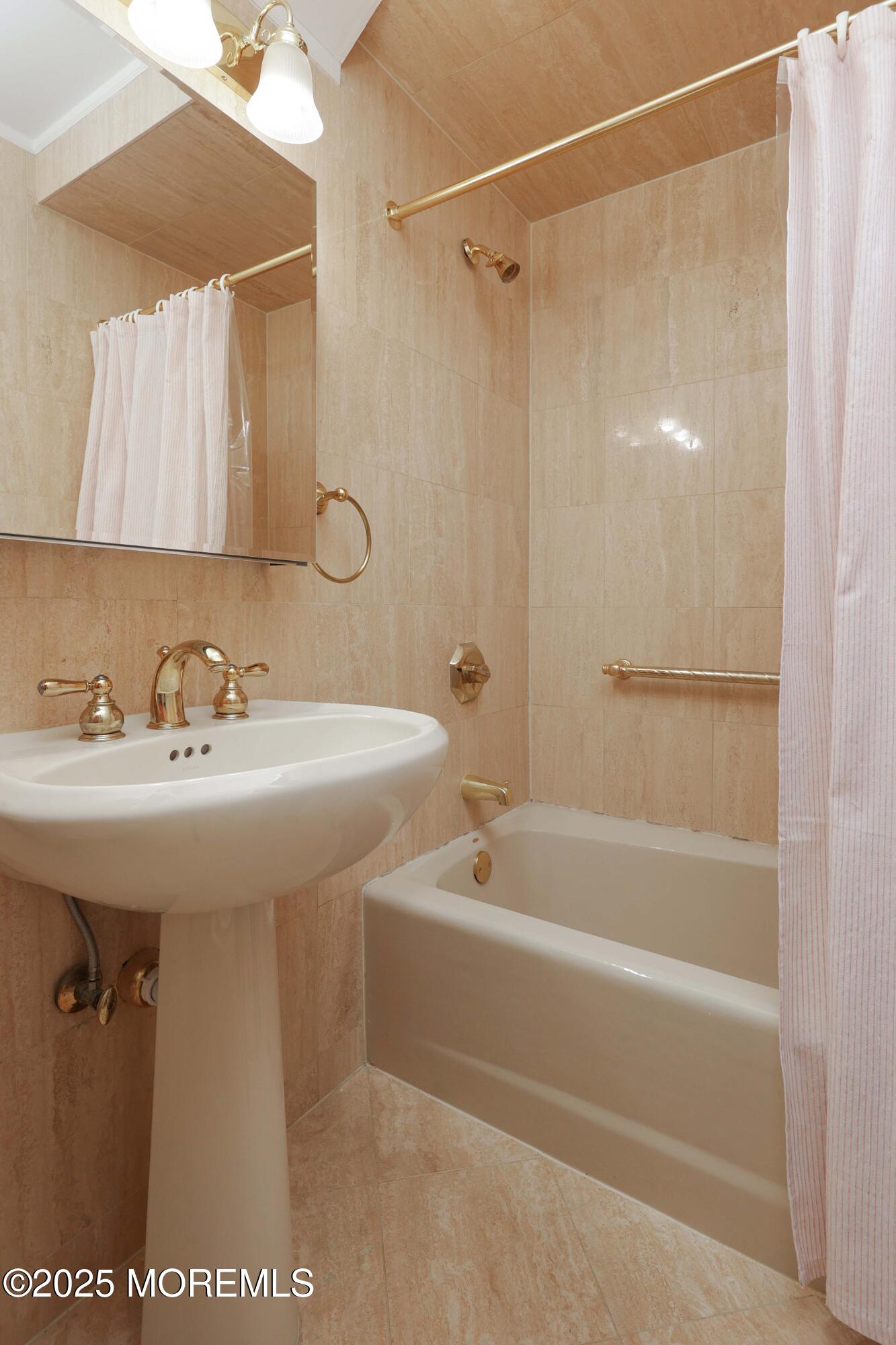 700 Ocean Avenue, Unit 531 Spring Lake, NJ 07762 - Photo 15 of 42 a bathroom with a shower a sink and a mirror