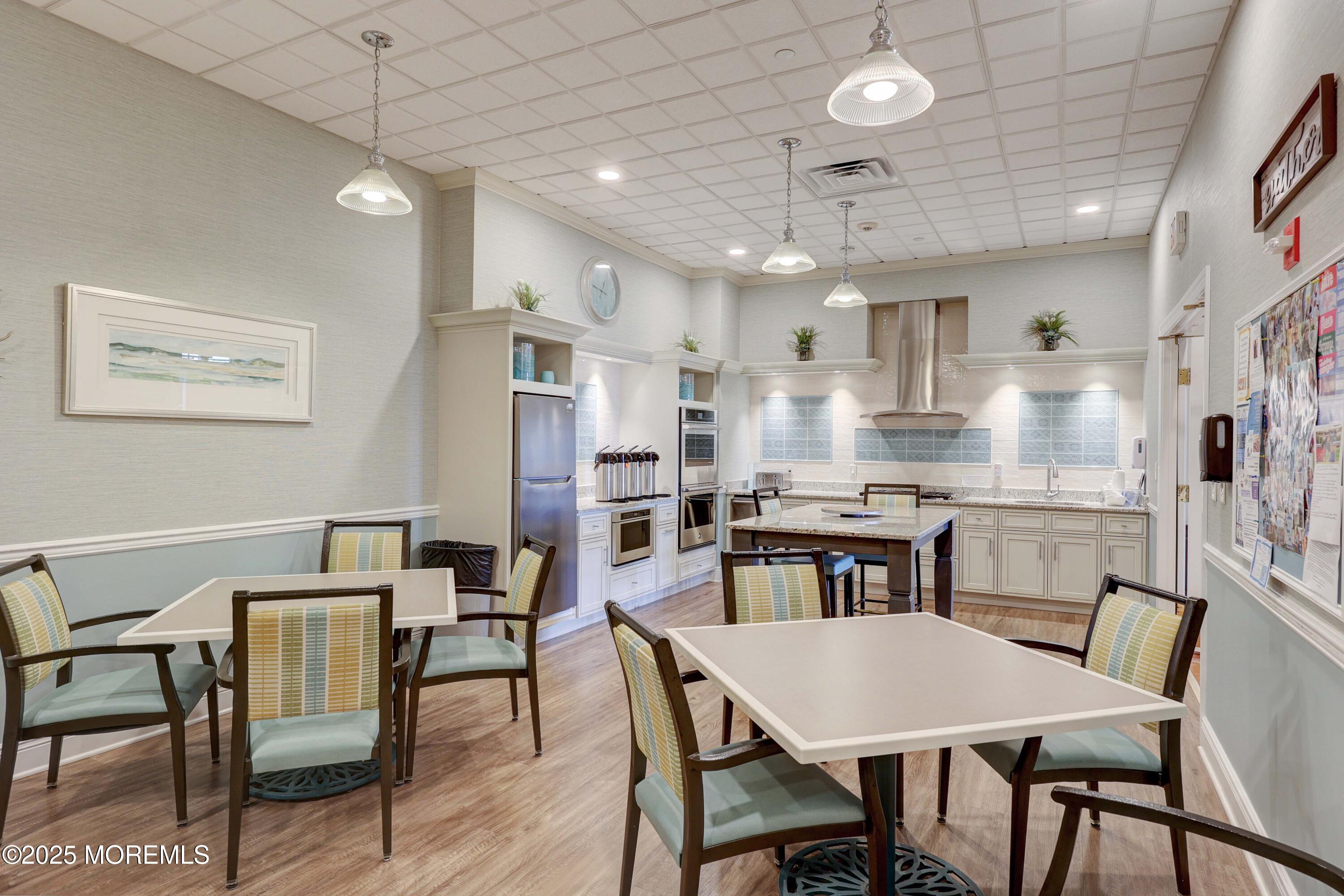 700 Ocean Avenue, Unit 531 Spring Lake, NJ 07762 - Photo 26 of 42 a view of a dining room with furniture a kitchen and chandelier