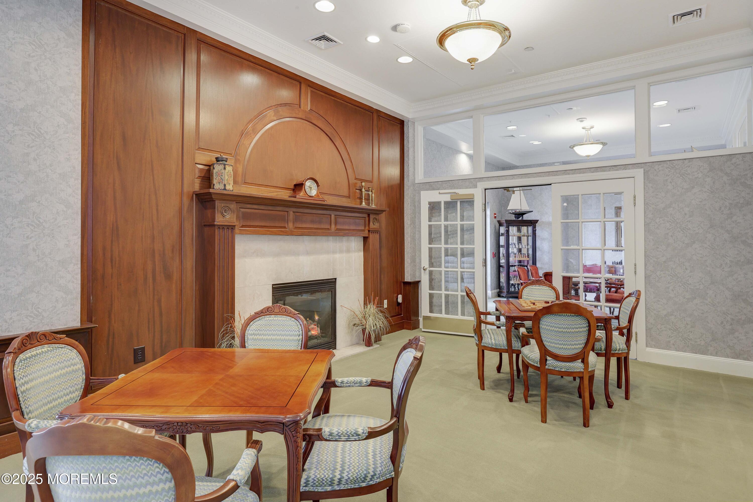 700 Ocean Avenue, Unit 531 Spring Lake, NJ 07762 - Photo 27 of 42 a dining room with furniture and fireplace