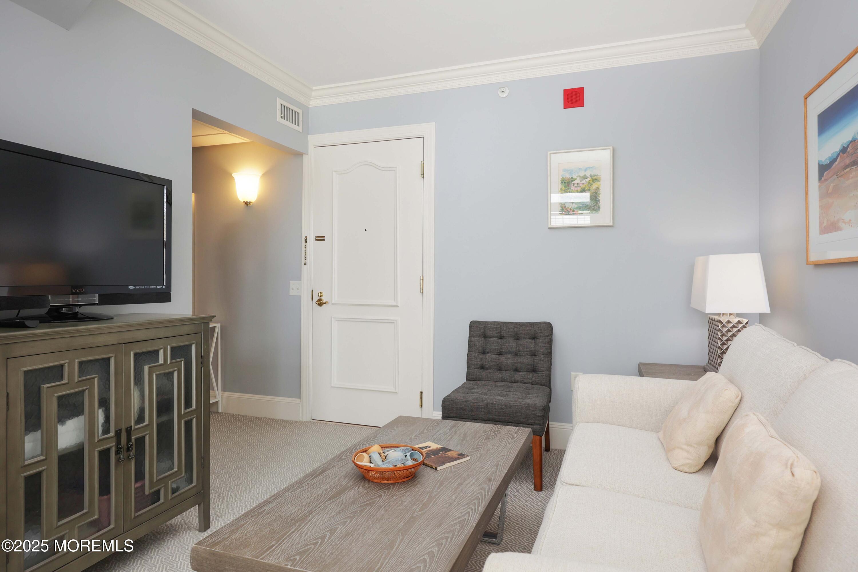 700 Ocean Avenue, Unit 531 Spring Lake, NJ 07762 - Photo 10 of 42 a living room with furniture and a flat screen tv