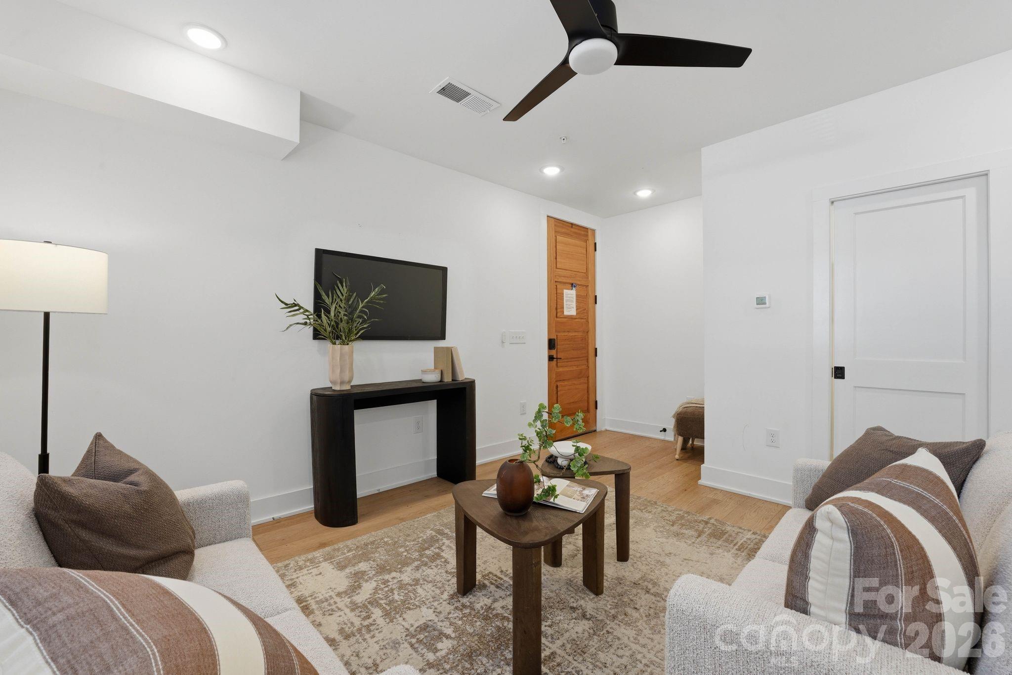 201 Grandin Road, Unit 6 Charlotte, NC 28208 - Photo 3 of 45 a living room with furniture and a flat screen tv