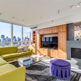 a living room with furniture a flat screen tv and a fireplace