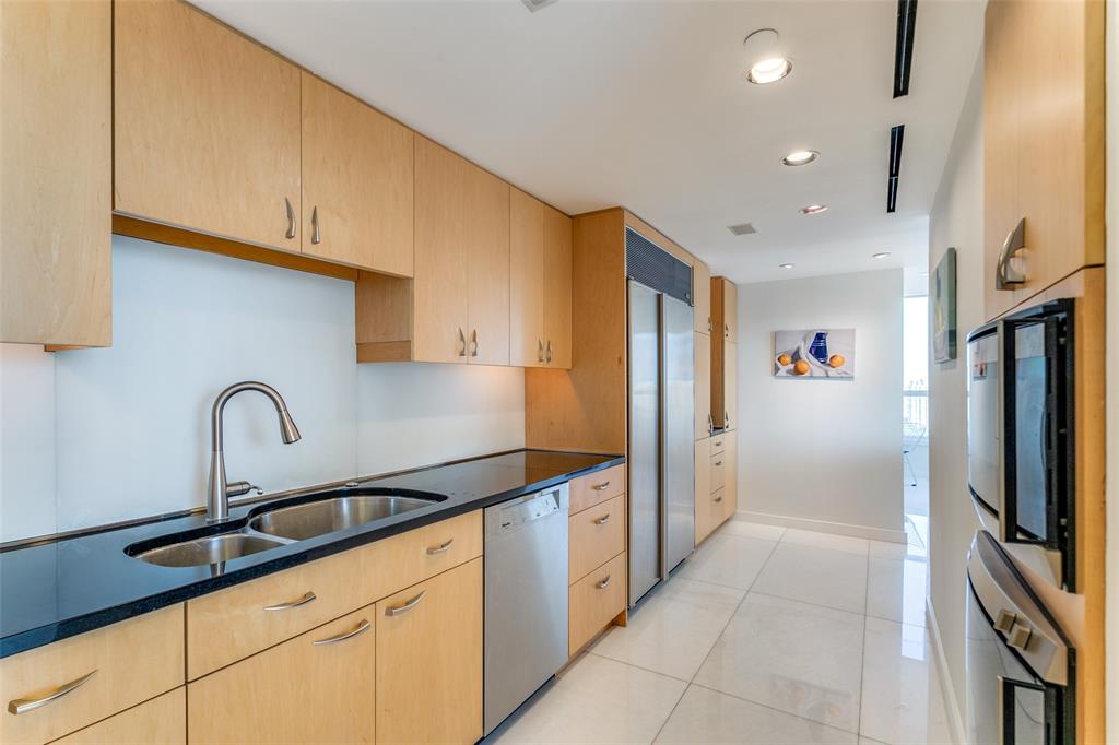 3030 McKinney Avenue, Unit 2301 Dallas, TX 75204 - Photo 13 of 34 a kitchen with stainless steel appliances granite countertop a sink and cabinets