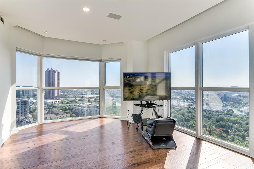 3030 McKinney Avenue, Unit 2301 Dallas, TX 75204 - Photo 21 of 34 a living room with furniture and a floor to ceiling window