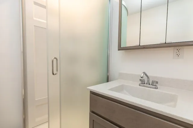 a bathroom with a sink and vanity