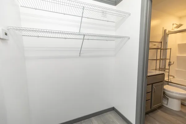 a bathroom with a granite countertop bathtub shower sink vanity and toilet